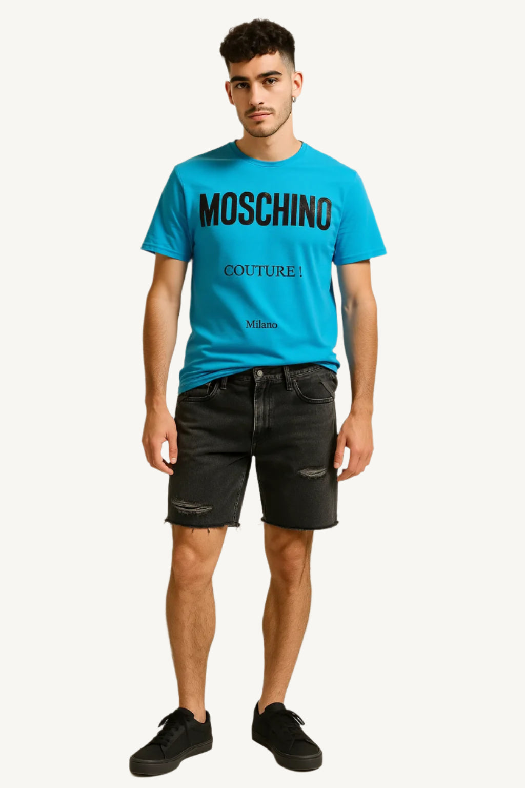 Man wearing a blue Moschino t-shirt and black shorts on a beige background
