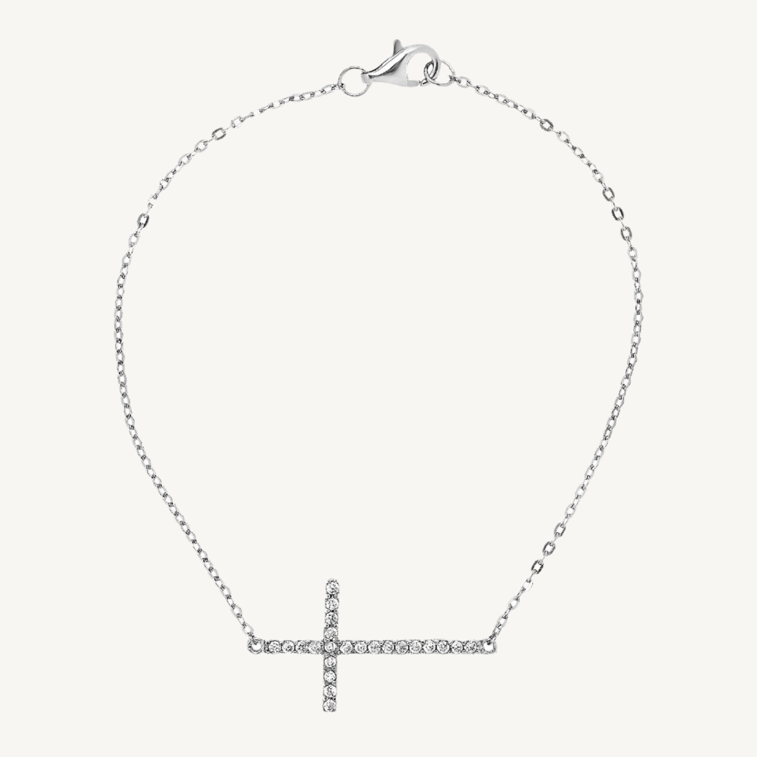 Elegant 7-inch bracelet featuring a classic cross design with sparkling cubic zirconia stones and a lobster clasp closure.