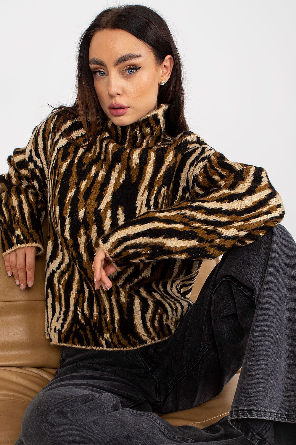 Woman wearing a zebra print sweater against a white background