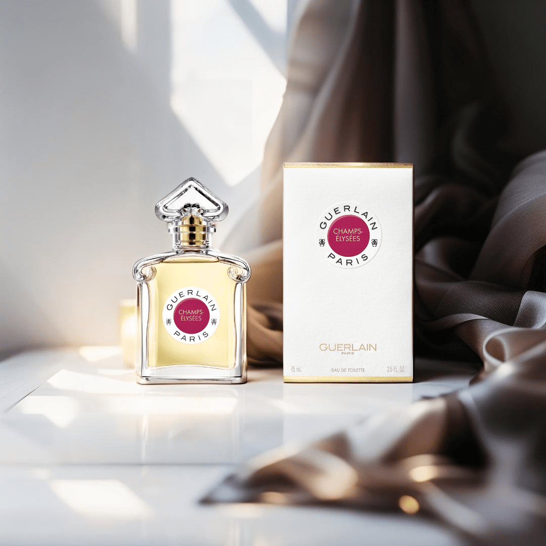 "Guerlain Champs-Élysées 2.5 oz Eau de Toilette Spray for Women – elegant glass bottle with a radiant pink hue, featuring the iconic inverted heart-shaped stopper, reflecting the vibrant and romantic fragrance."