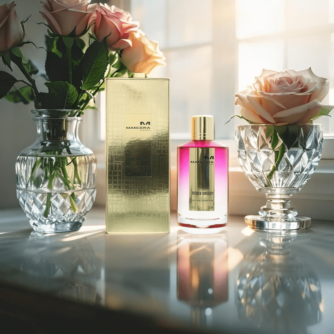 "Mancera Roses Greedy Eau de Parfum 4 oz – a luxurious glass bottle with a gold-toned cap, containing a pink-hued fragrance, reflecting elegance and sophistication."