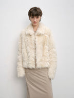 Person wearing a cream fur jacket against a plain background