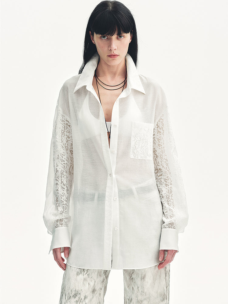 Woman wearing a white shirt with lace sleeves on a white background