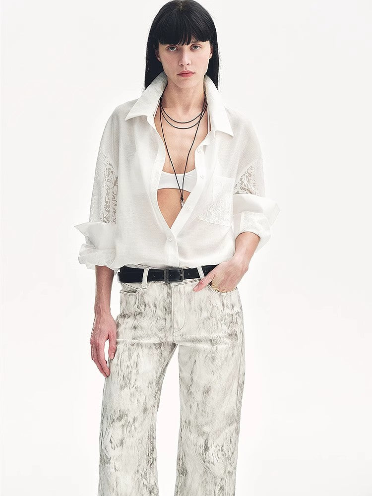 Woman wearing a white blouse and patterned pants on a white background