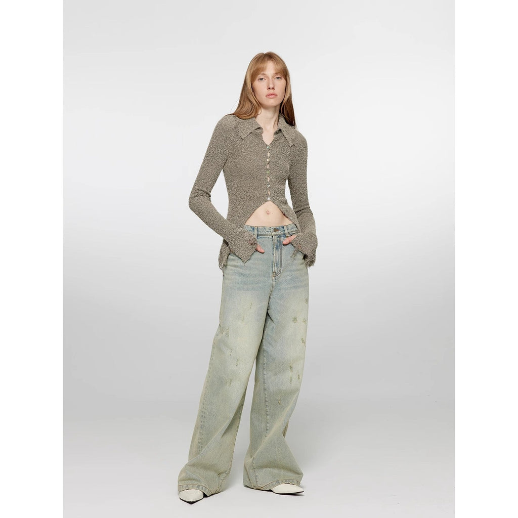 Woman wearing a brown knitted sweater and light blue jeans on a white background