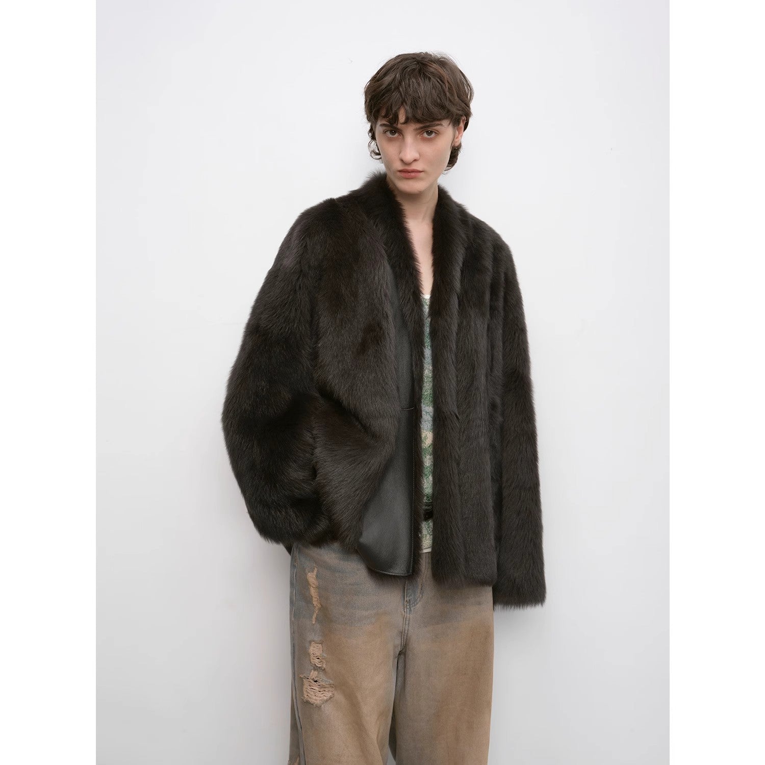 Person wearing a dark fur coat on a white background