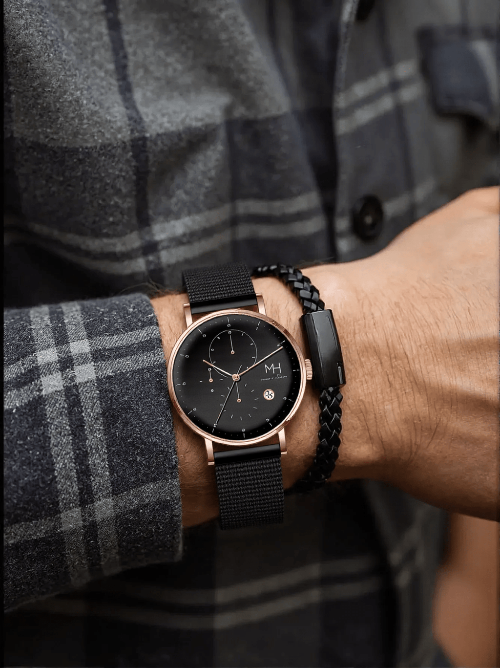 Marco Milano MH99199G1 men’s chronograph watch with polished rose gold-tone stainless steel case, black-coated bracelet, black dial, and stopwatch function – stylish Japanese quartz timepiece.