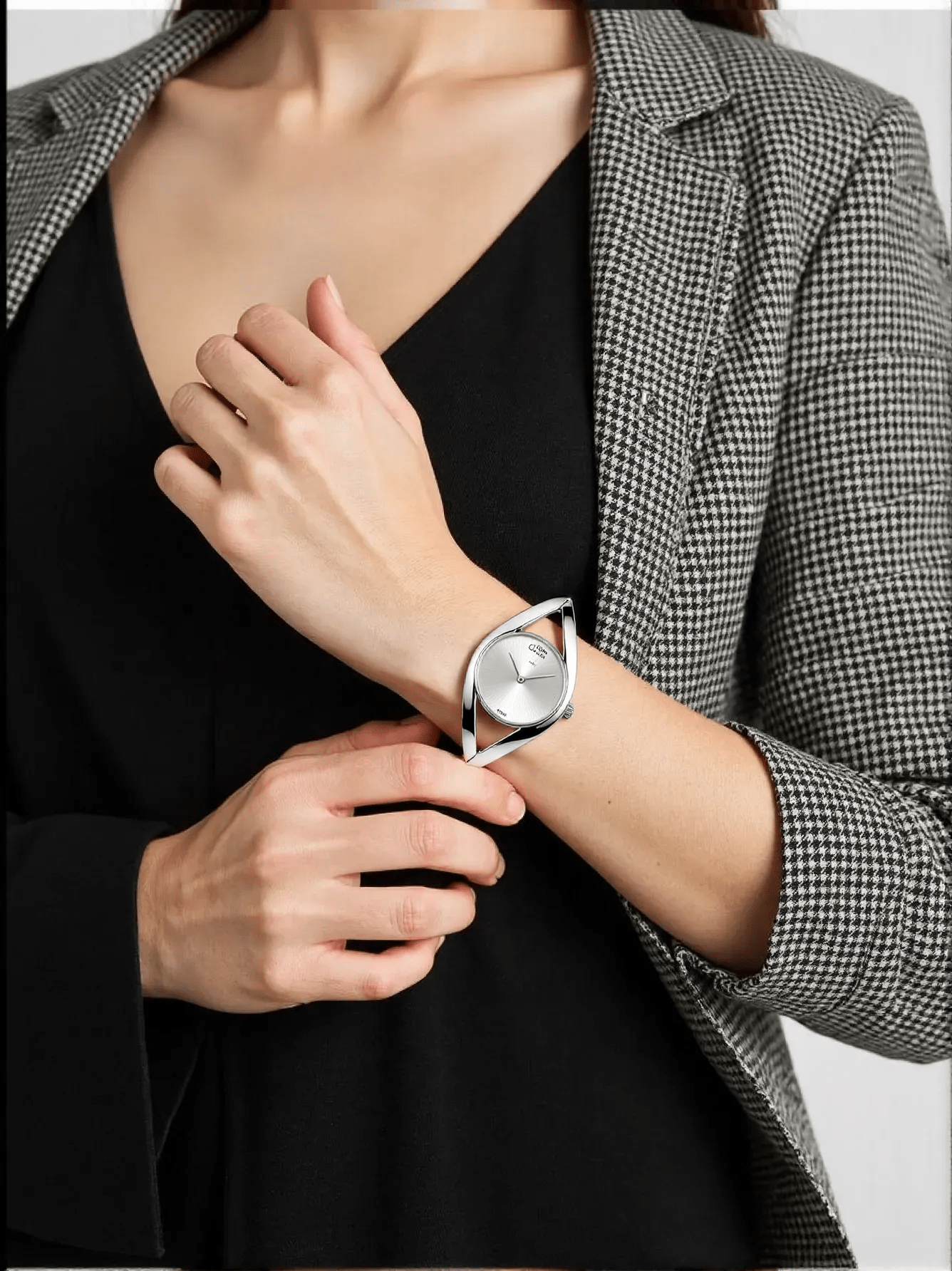 Stylish ladies’ silver-tone watch by Calvin Klein with a polished stainless steel case and strap, silver dial, slim profile, and quartz movement with 3 bar water resistance.