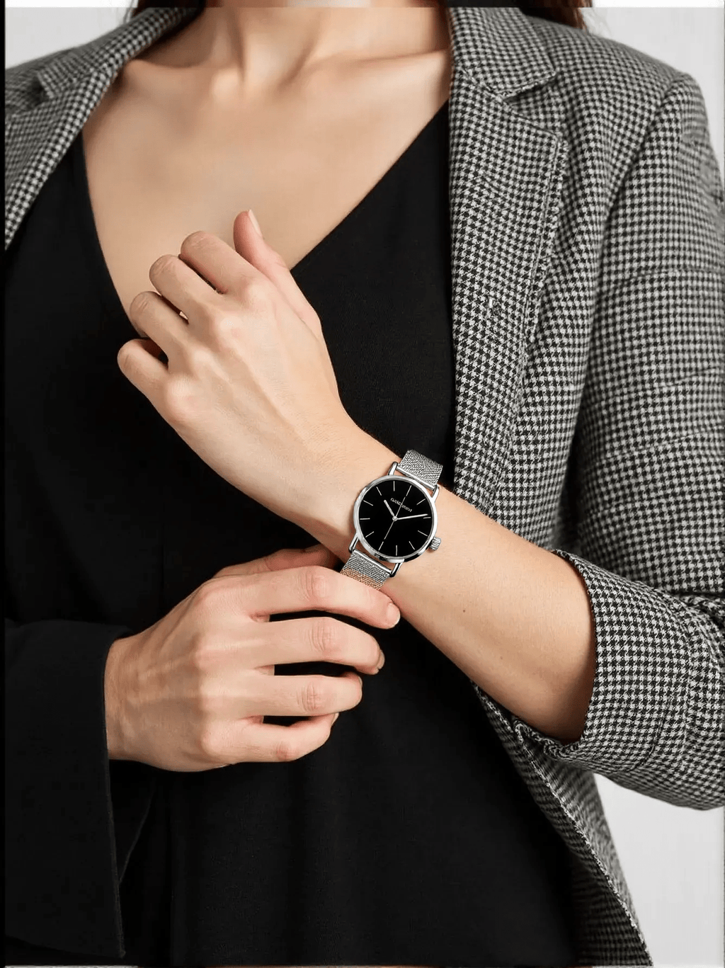 Sophisticated men’s watch by Calvin Klein featuring a polished silver-tone stainless steel case and strap, black dial, quartz movement, and 3 bar water resistance.