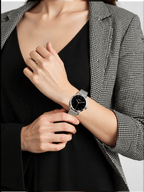 Sophisticated men’s watch by Calvin Klein featuring a polished silver-tone stainless steel case and strap, black dial, quartz movement, and 3 bar water resistance.