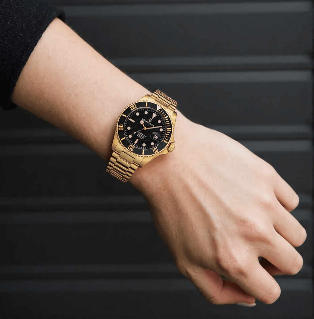 Revue Thommen Diver men’s automatic watch with black dial, gold-tone stainless steel strap, luminous hands, and 300m water resistance, Swiss made.