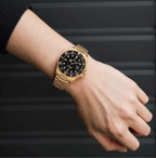 Revue Thommen Diver men’s automatic watch with black dial, gold-tone stainless steel strap, luminous hands, and 300m water resistance, Swiss made.