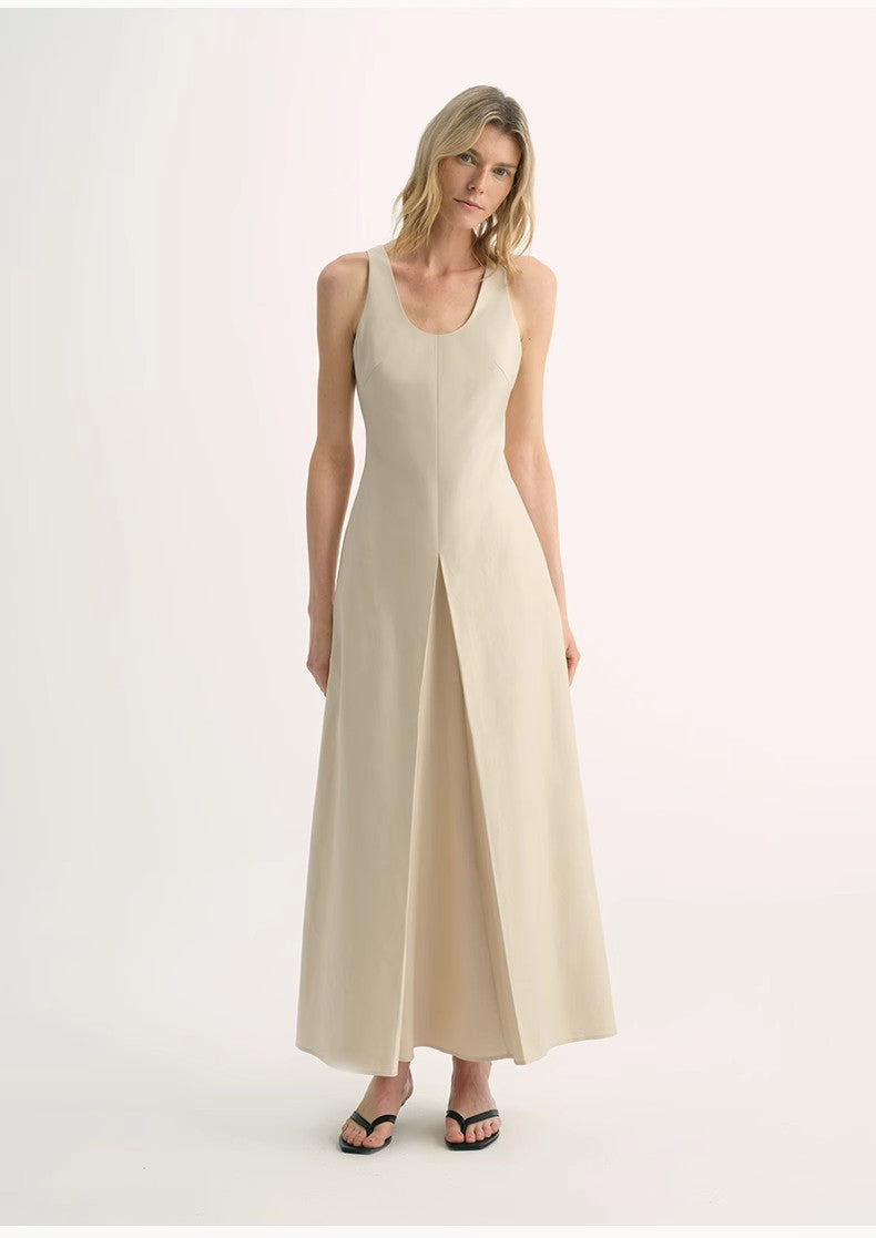 Woman wearing a beige sleeveless dress on a white background