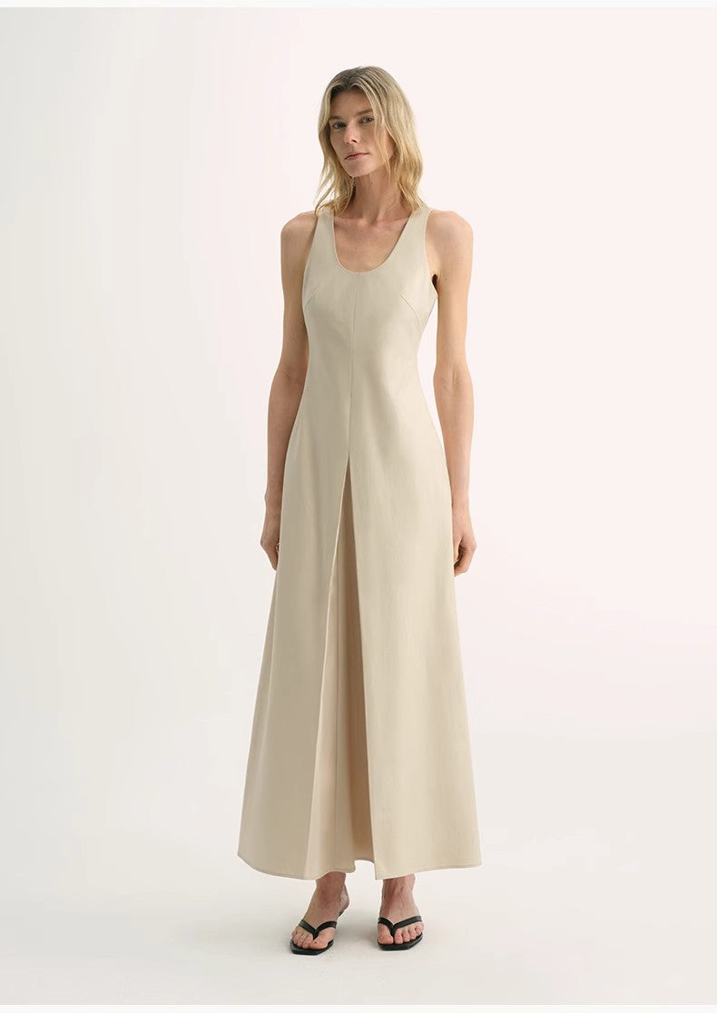 Woman wearing a beige sleeveless jumpsuit on a white background