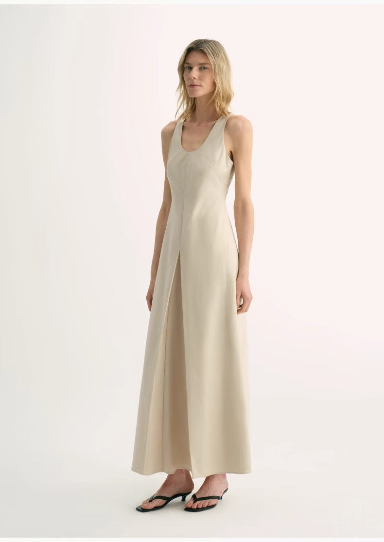 Woman wearing a beige sleeveless dress on a white background