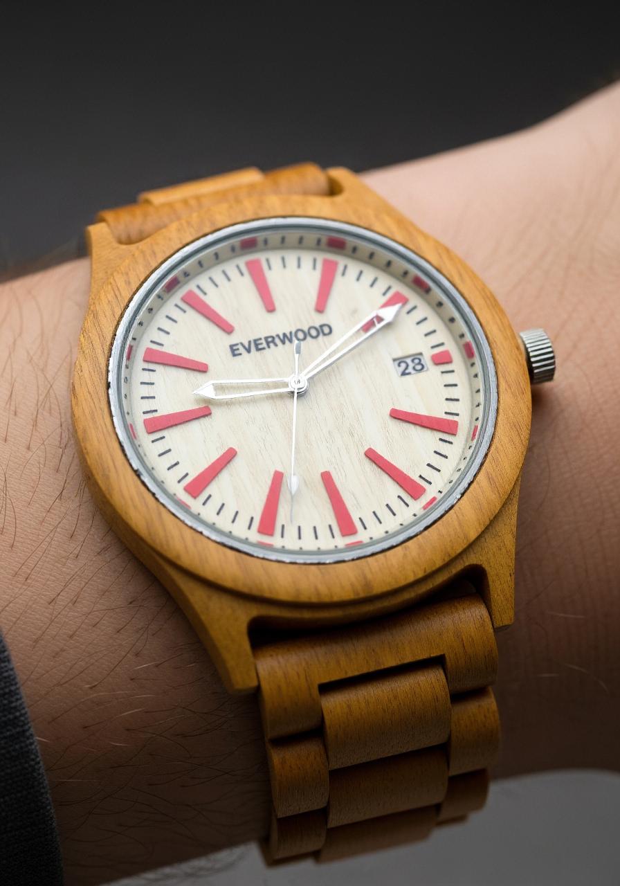 Wooden watch with red accents on a wrist, brand 'Everwood' visible