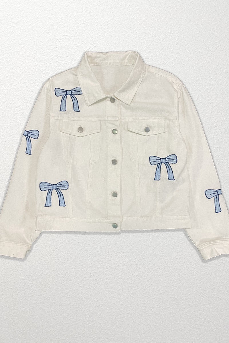 White denim jacket with blue bow accents on a white background