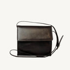 "Full-grain calfskin leather shoulder bag with three compartments, zippered rear pocket, and adjustable shoulder strap"