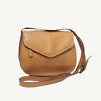"Elegant full-grain calfskin leather shoulder bag with zippered front and back pockets, three compartments, and adjustable strap"