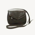 Elegant full-grain calfskin leather shoulder bag with front and back zippered pockets, leather lining, and adjustable strap.