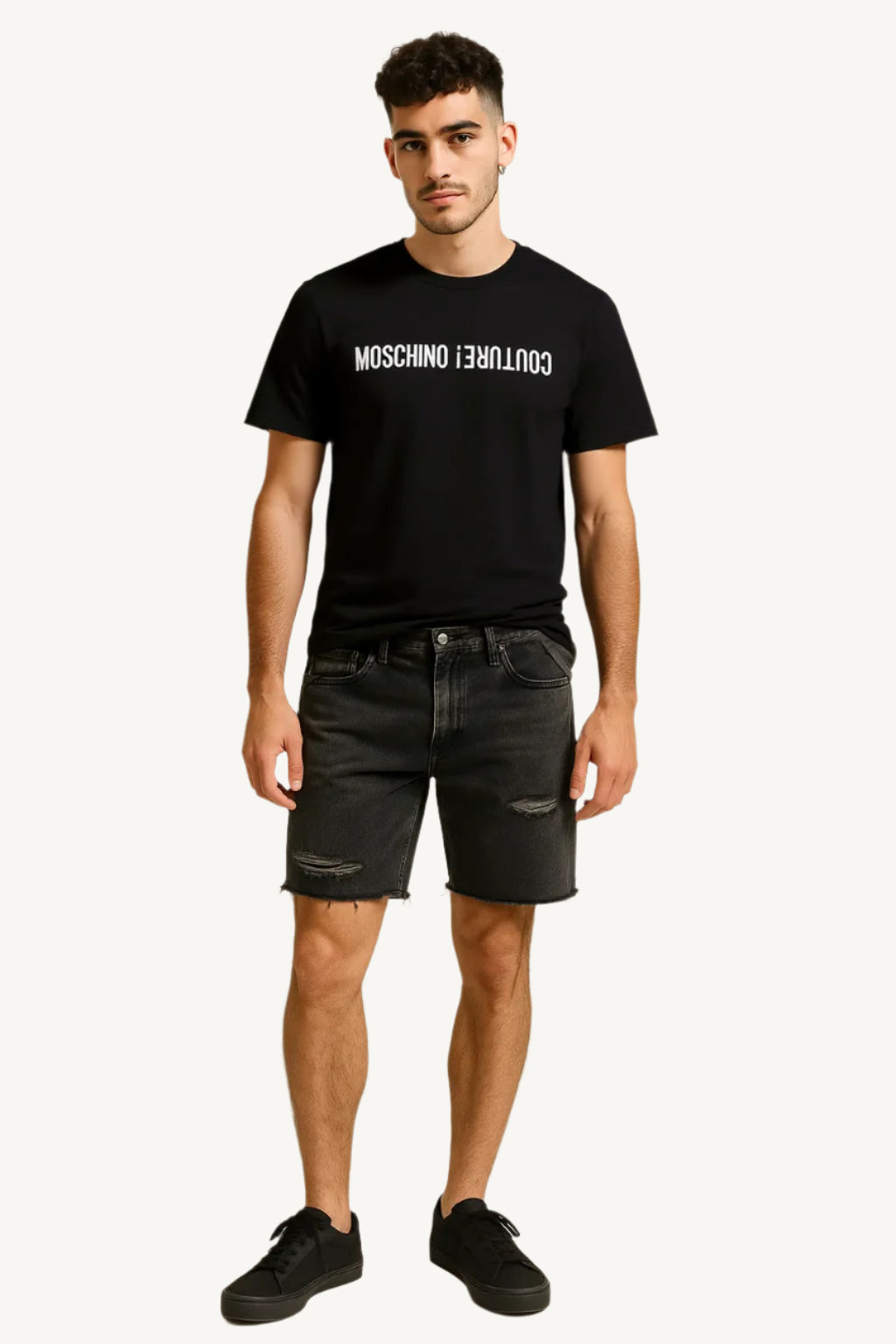 Man wearing a black t-shirt with brand logo and black shorts on a beige background