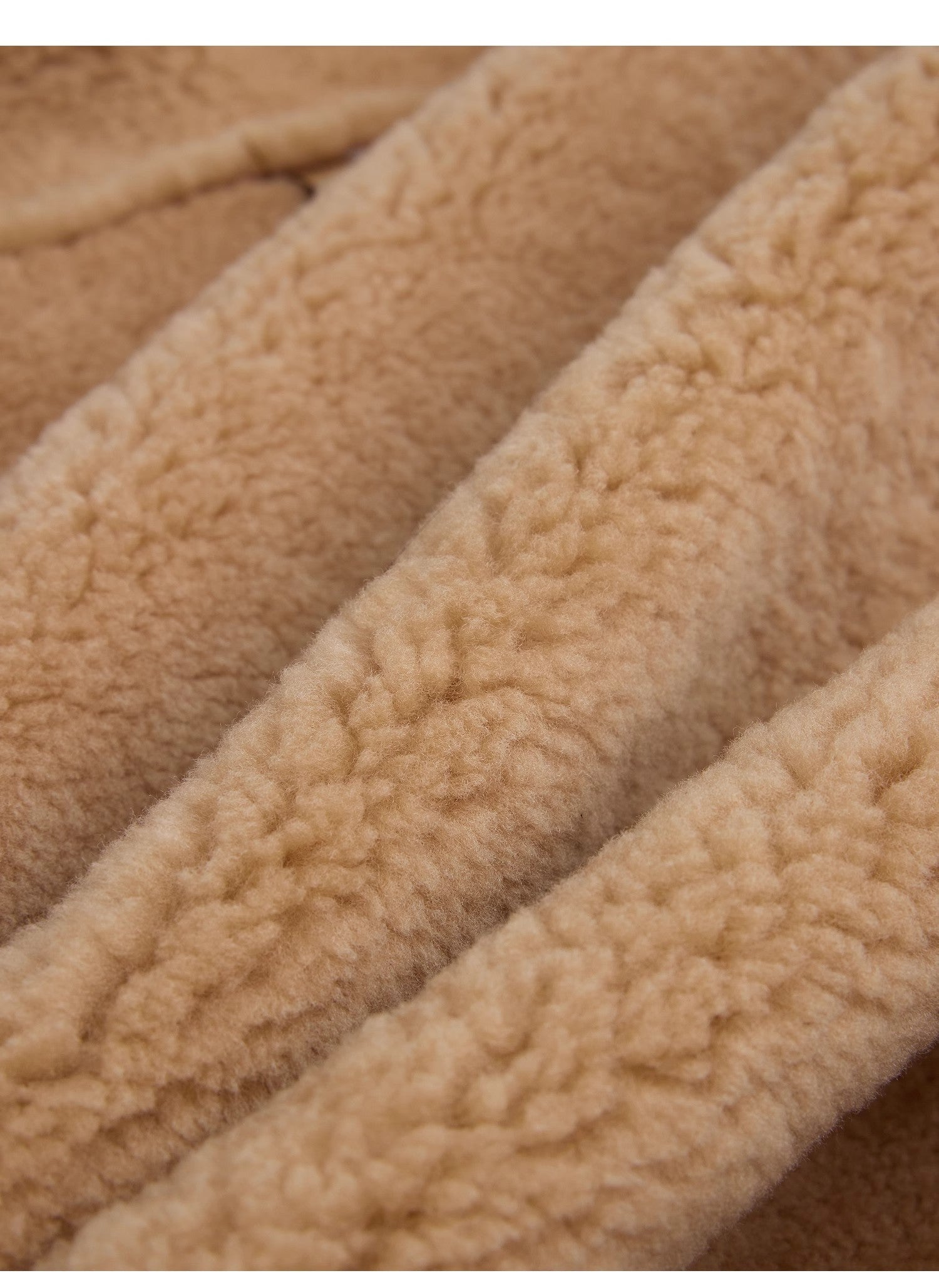 Close-up of beige fleece fabric with a textured pattern