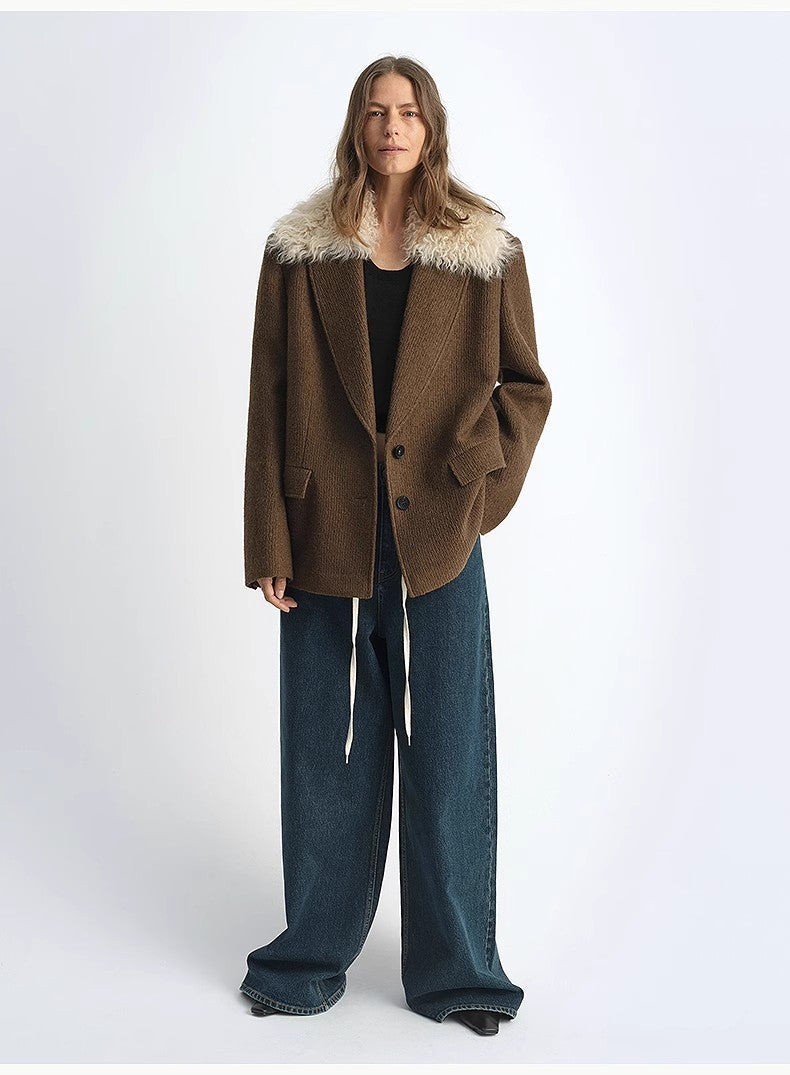 Person wearing a brown coat with fur trim on a white background