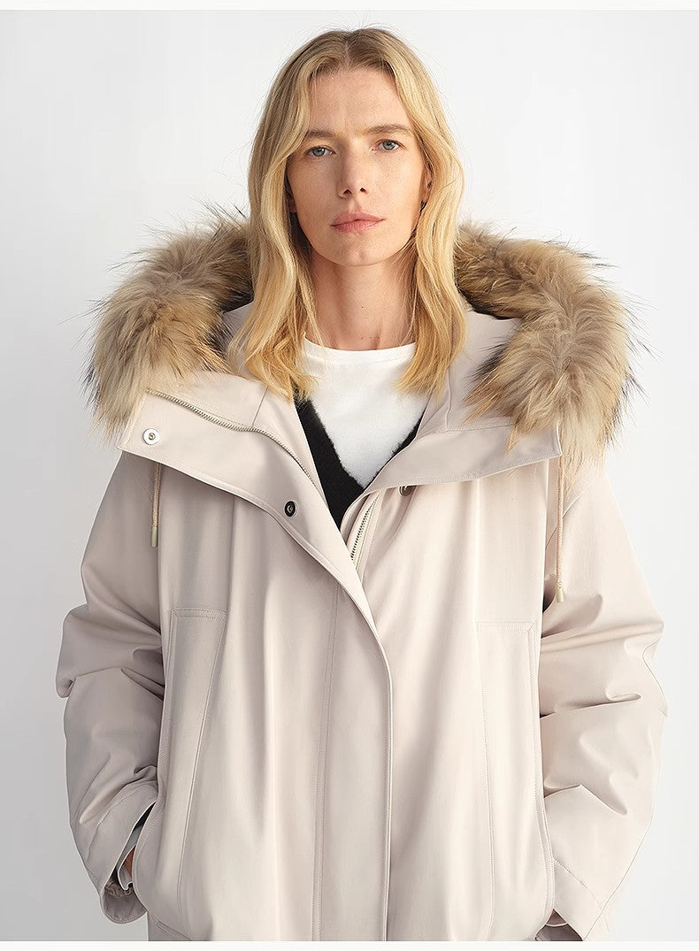 Person wearing a beige parka with a fur-lined hood on a white background