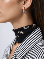 Fine white gold oval hoop earrings with a hammered texture, secured with a snap lock closure for added style and interest.