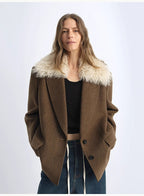 Woman wearing a brown coat with white fur collar on a white background