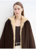 Woman wearing a brown coat with beige fur lining against a white background
