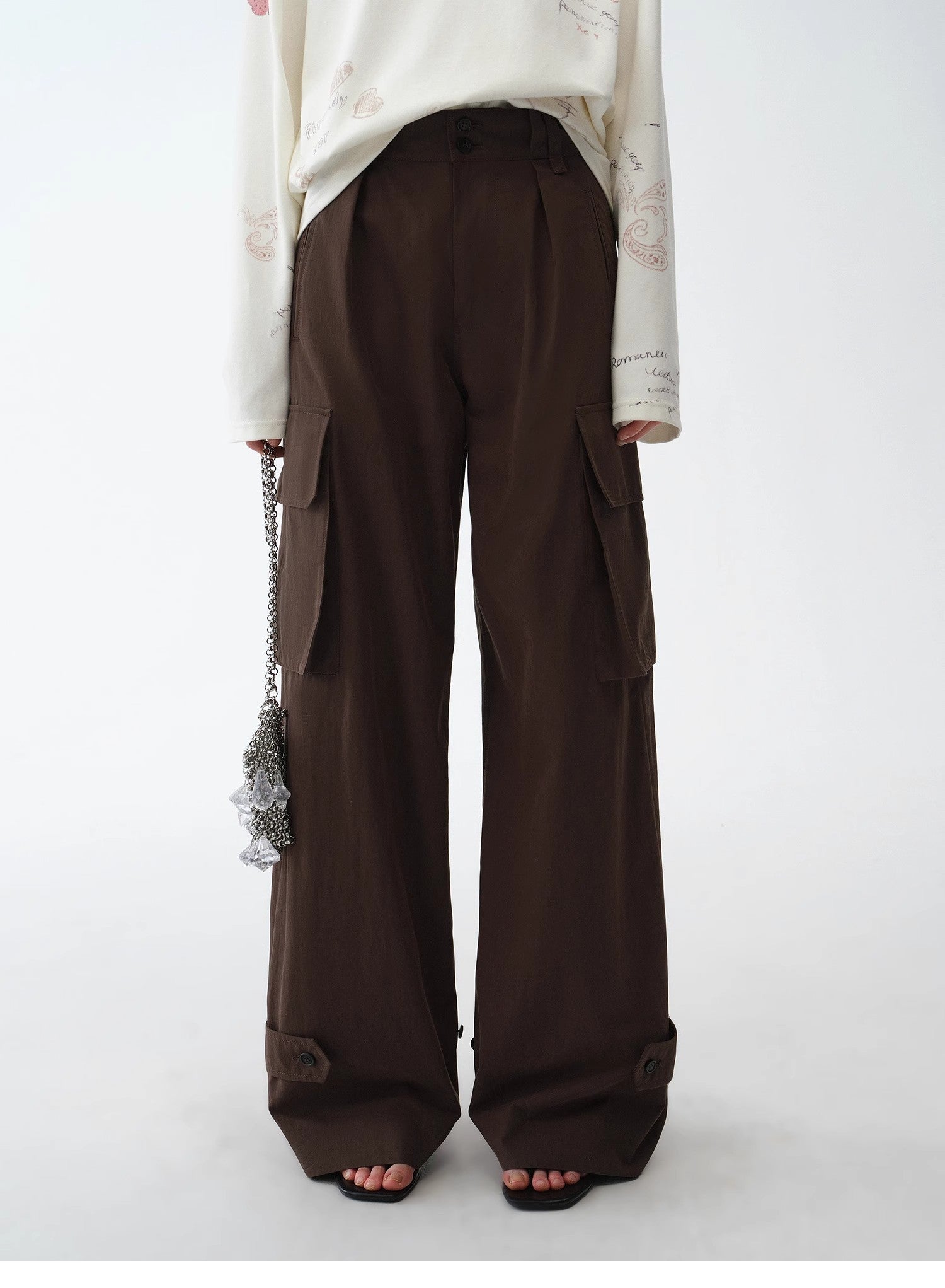 Brown cargo pants worn by a person on a white background