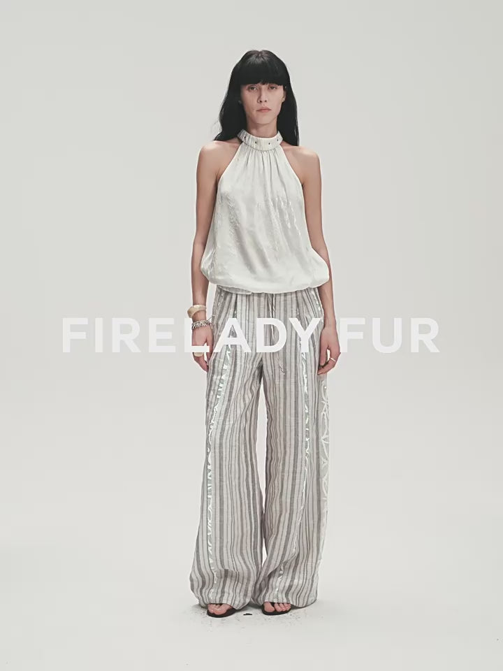 Woman wearing a white top and striped pants on a plain background with 'FIRE LADY FUR' branding.