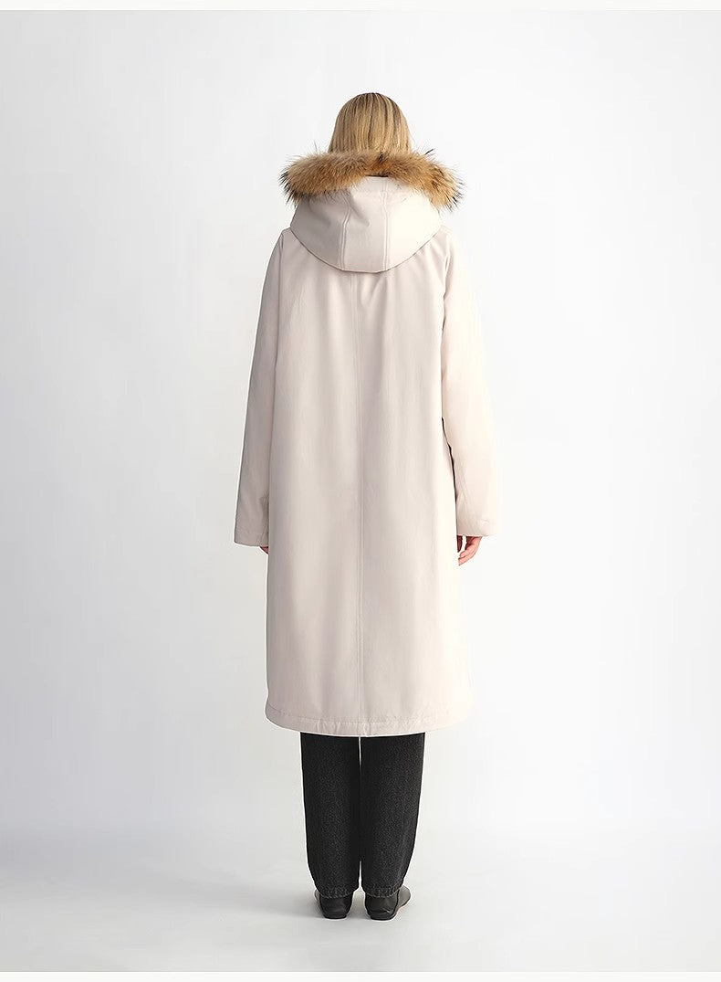 Person wearing a beige coat with fur hood on a white background