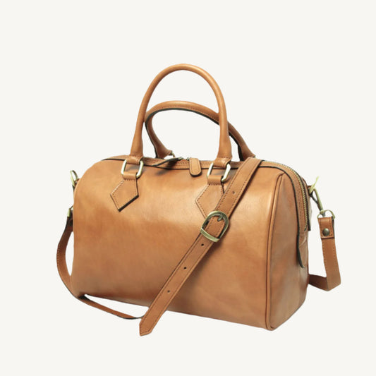 Elegant full grain leather shoulder bag, 31x20x18 cm, with double handles, two zipped compartments, adjustable strap, protective bottom feet, and lined with polyester.
