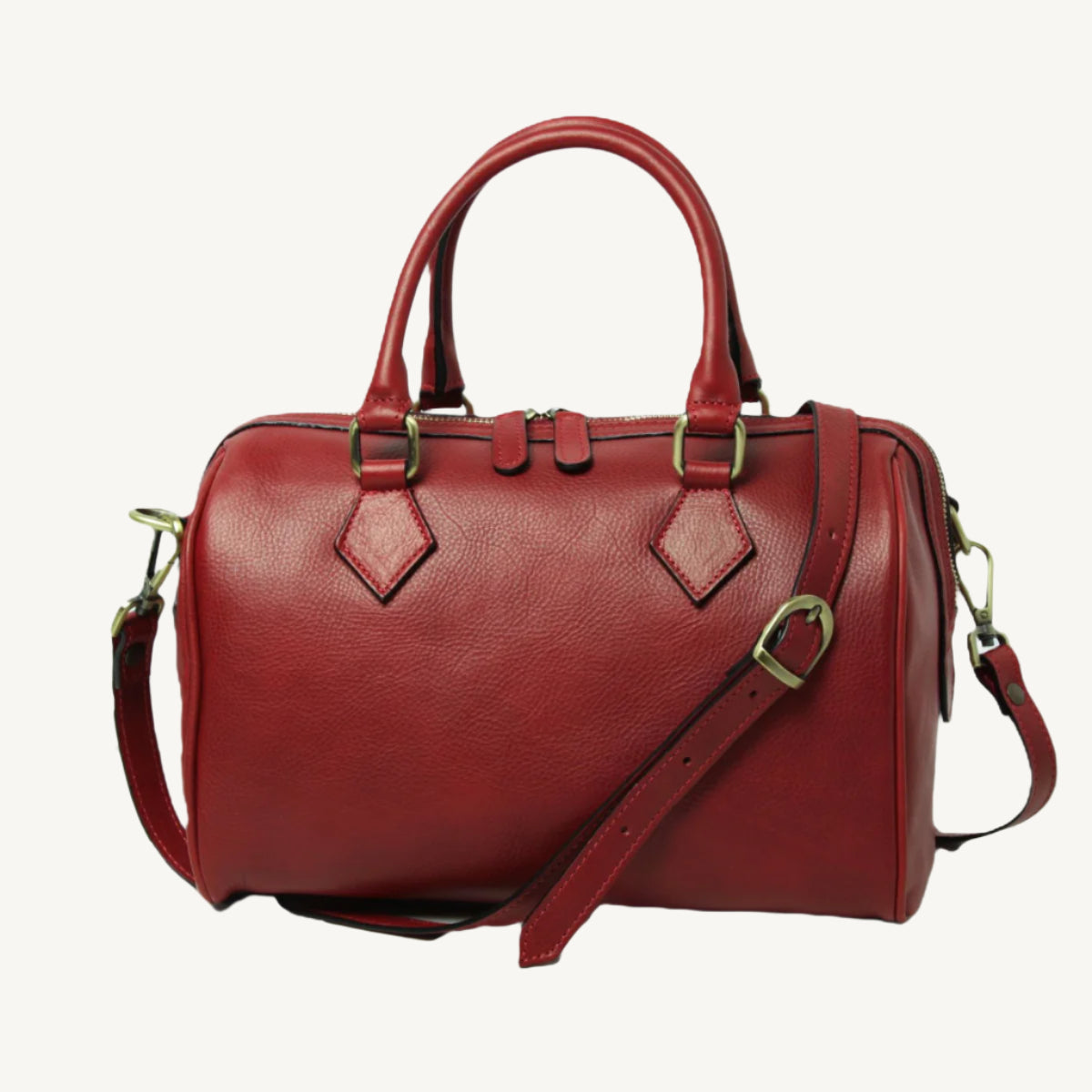 Elegant full-grain leather shoulder bag, 31x20x18 cm, with double handles, two interior zipped pockets, adjustable/removable strap, bottom feet, and polyester lining.