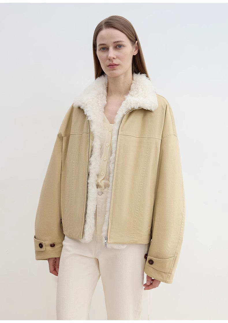 Woman wearing a beige jacket with white fur lining on a white background