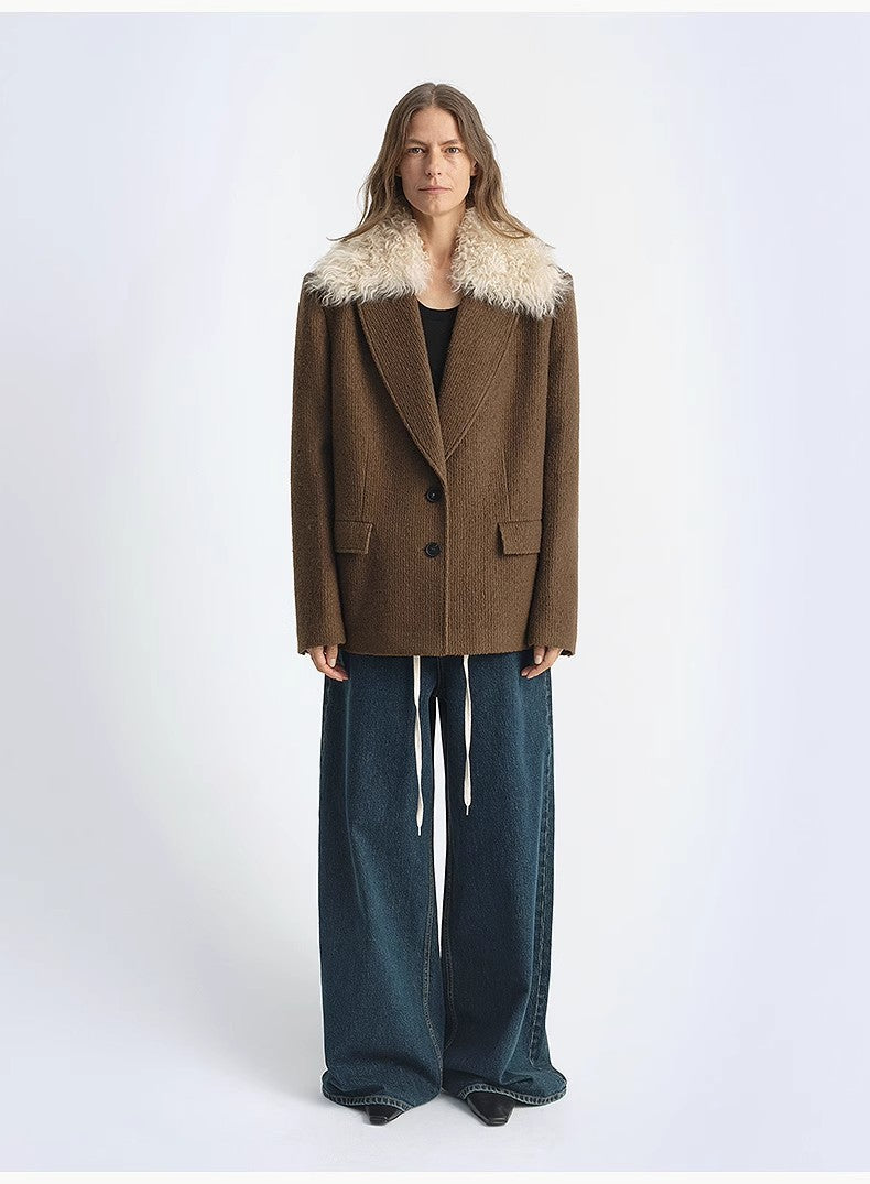 Person wearing a brown coat with fur collar on a white background