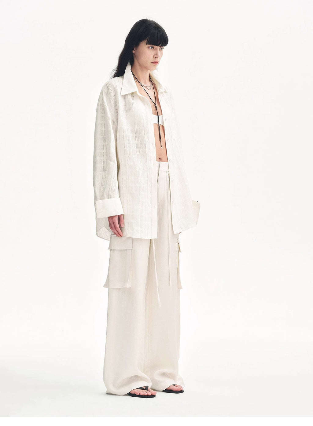 Person wearing a white outfit on a white background