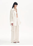 Person wearing a white outfit on a white background