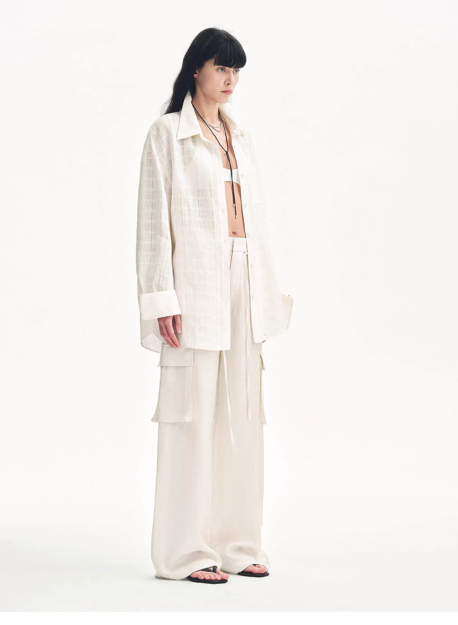 Person wearing a white outfit on a white background