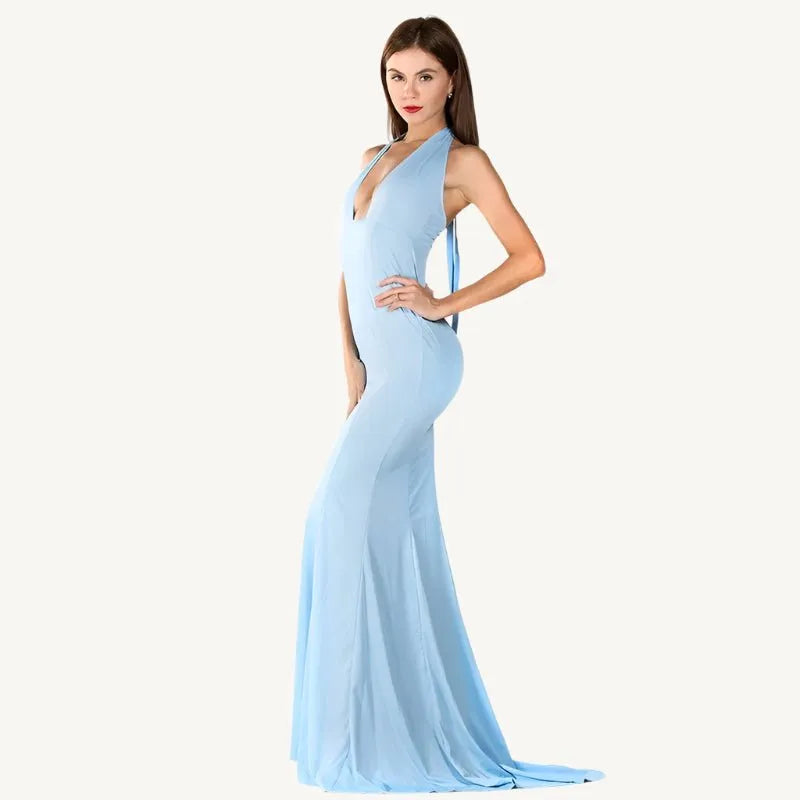 Graceful woman in a light blue Evelyn Belluci evening gown with a deep plunge neckline and flowing silhouette — perfect for weddings, galas, and elegant events.