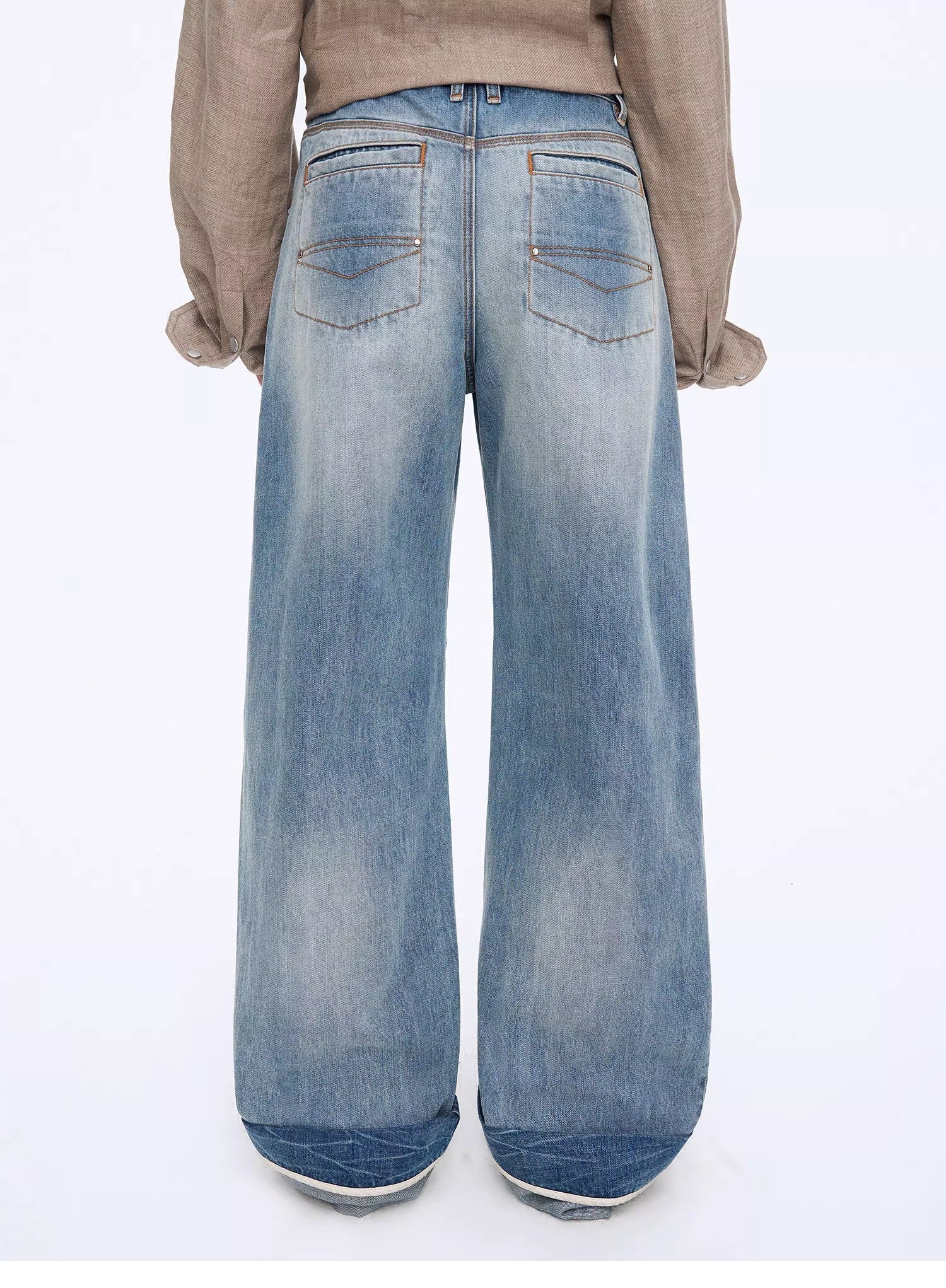 Light blue wide-leg jeans worn by a person on a white background