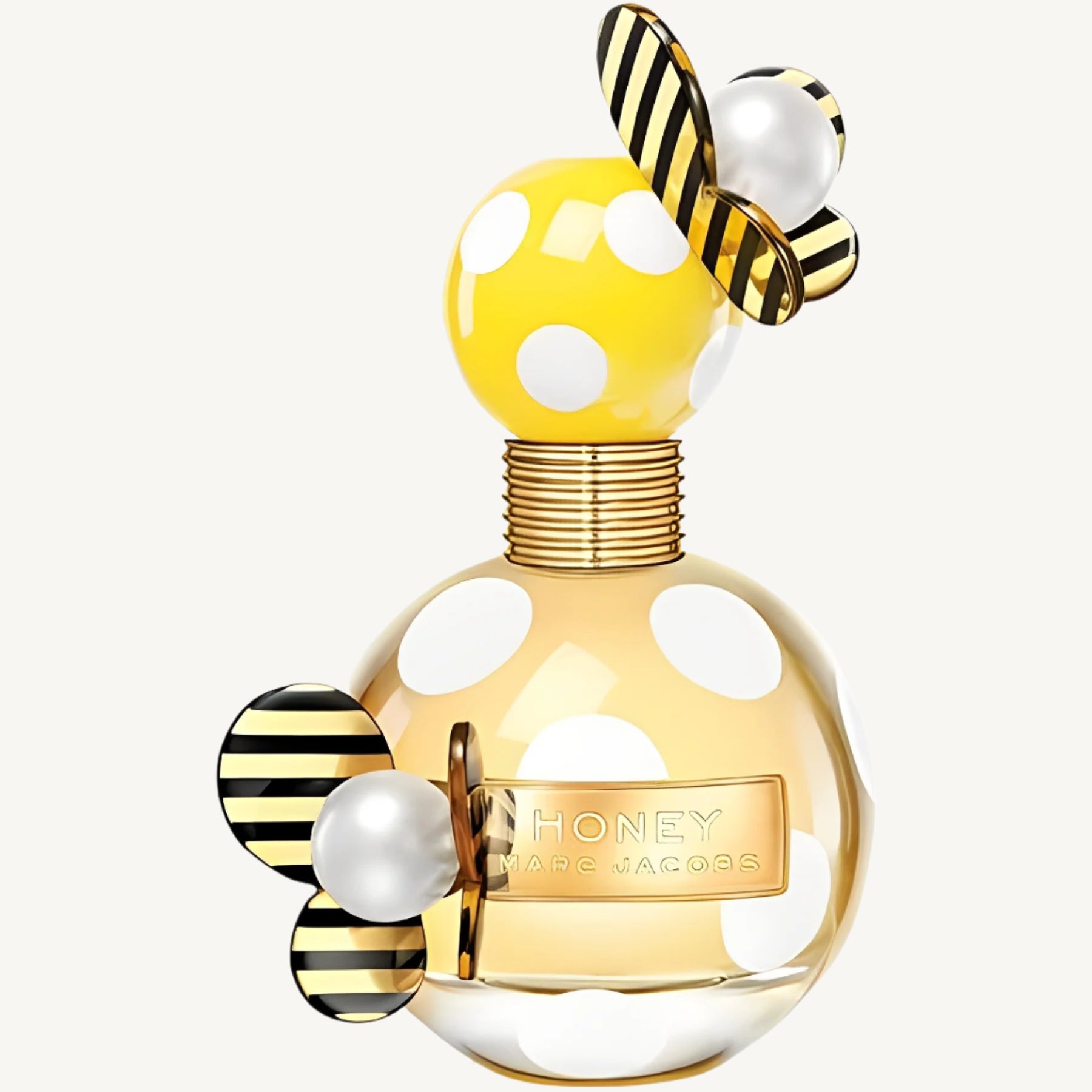 "Marc Jacobs Honey Eau de Parfum 3.3 oz – vibrant yellow bottle adorned with white polka dots and a playful butterfly-shaped cap, presented alongside its matching yellow polka dot box."