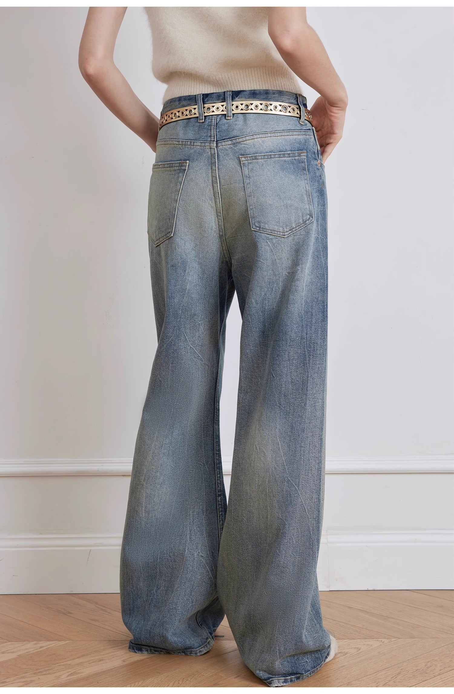Person wearing wide-leg jeans with a neutral background