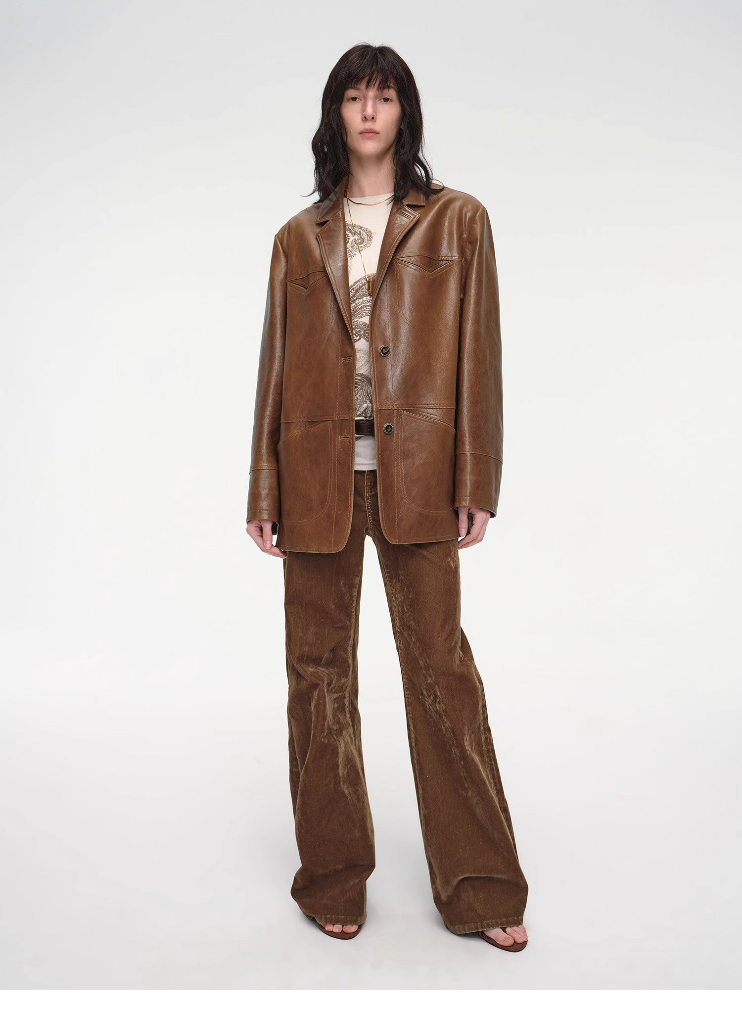 Person wearing a brown leather suit on a white background