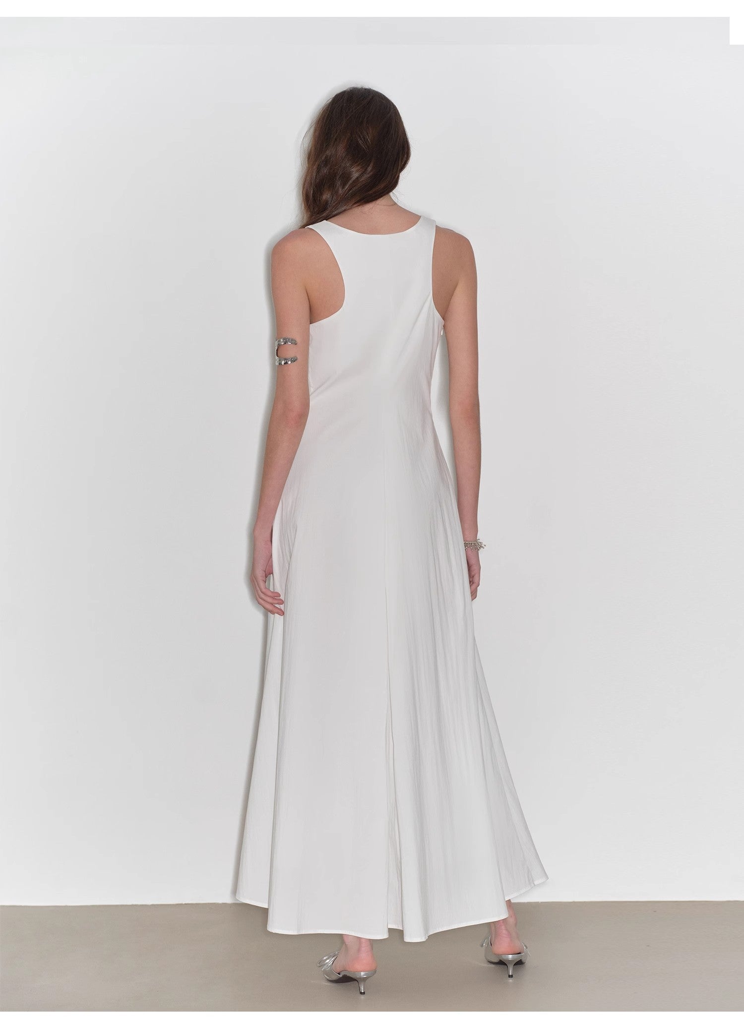 Woman wearing a white dress against a white background