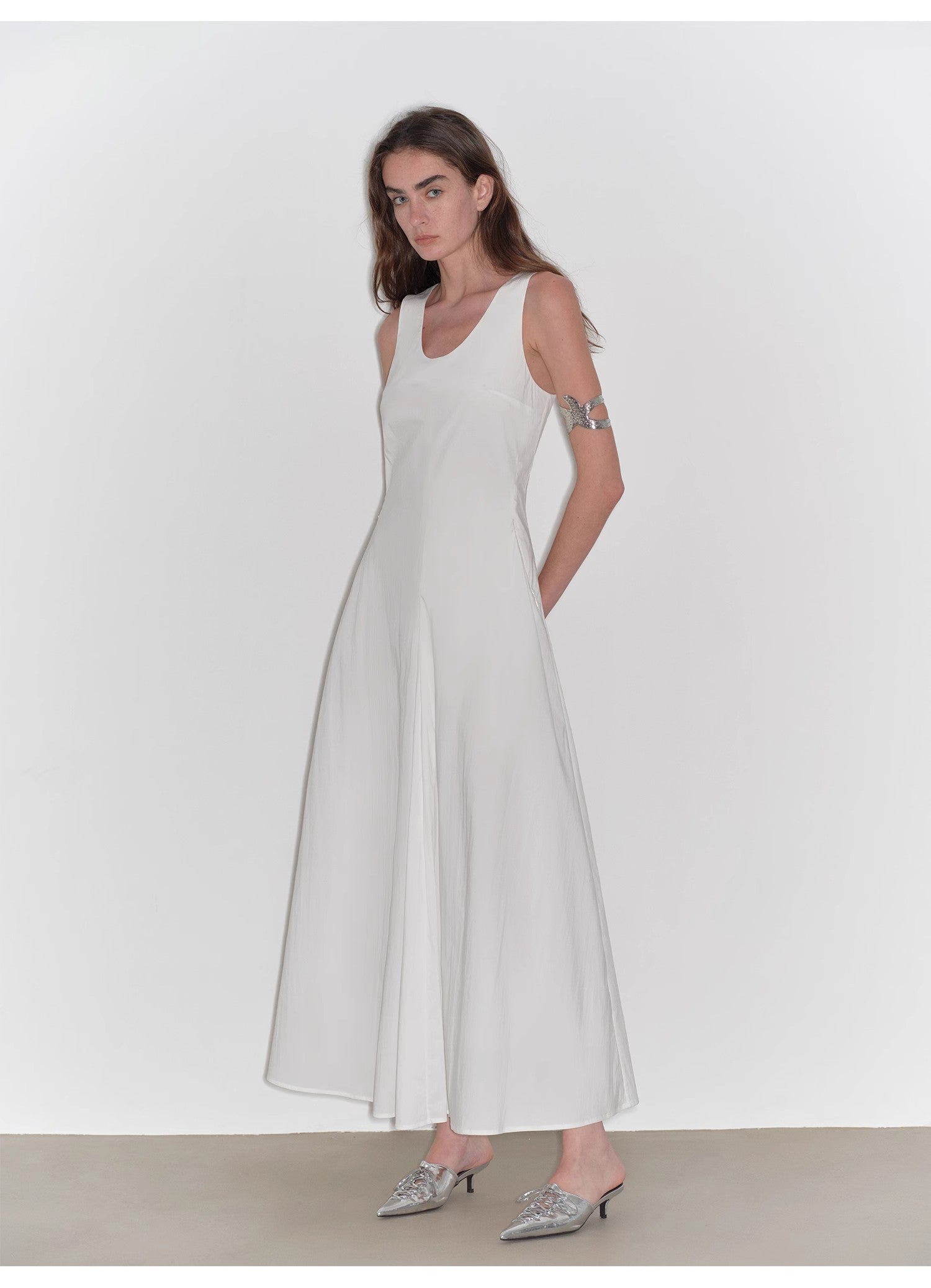 Woman wearing a white dress with a plain background