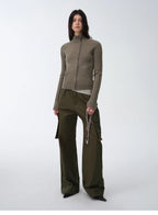 Woman wearing a green outfit with a jacket and pants on a white background