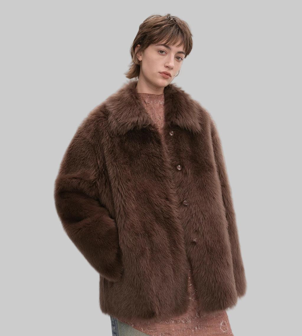 Person wearing a brown fur coat on a white background